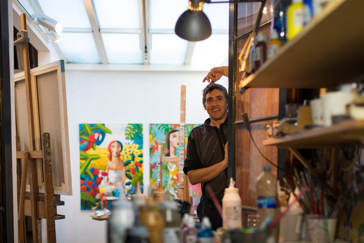 The artist Didier Lourenço standing in his studio